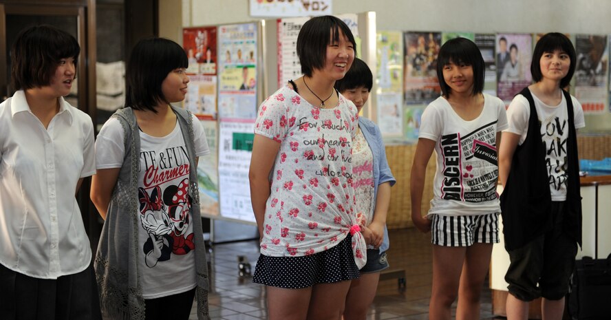 Nanase Abe, center, a student from Tanohata Junior High School, introduces herself to base members participating in a Homestay event during the opening ceremony at the Civic Center in Misawa City, Japan, Aug. 2, 2013. Base members who volunteered for the event opened their homes to the students for a weekend where they shared cultures and learned about each other. (U.S. Air Force photo by Senior Airman Kia Atkins)