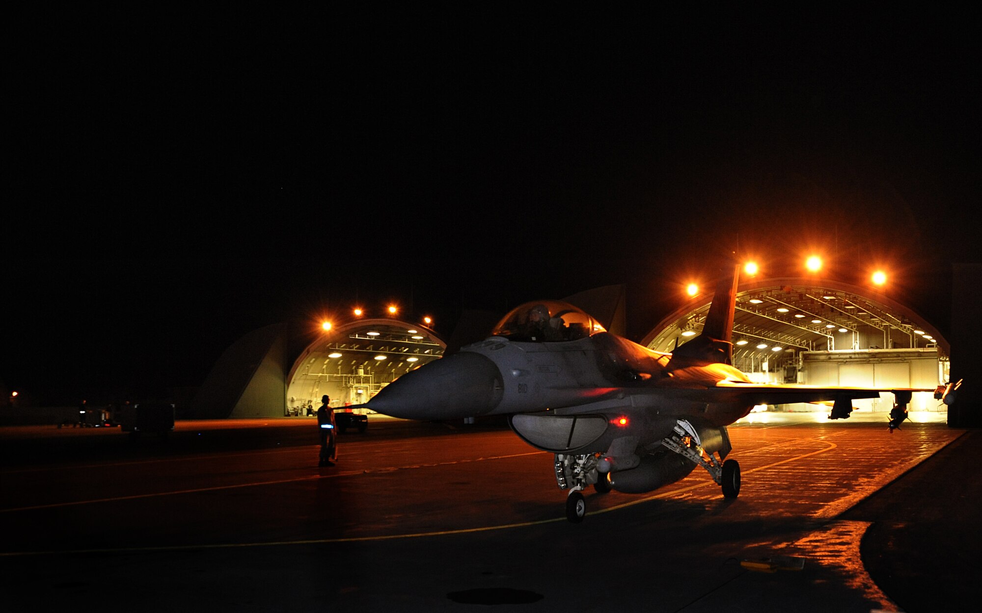 A U.S. Air Force F-16 Fighting Falcon piloted by Capt. Matthew Kimmel, 14th Fighter Squadron, taxis the flight line at Misawa Air Base, Japan, Aug. 1, 2013. Throughout the week, night flying operations were implemented to assess electronic warfare readiness across the 35th Maintenance Group. (U.S. Air Force photo by Senior Airman Derek VanHorn)