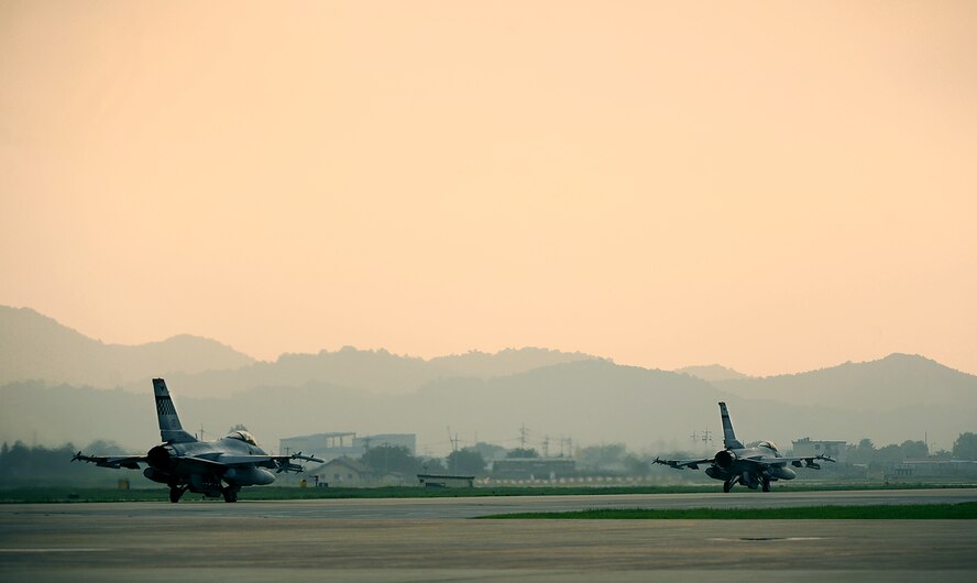 Two F-16 Fighting Falcons from the 36th Fighter Squadron taxi down the flight line before taking off for the first combat sortie of Operational Readiness Exercise Beverly Midnight 13-03 at Osan Air Base, Republic of Korea, Aug. 6, 2013. This is Osan’s fourth simulated wartime contingency exercise in 2013 that will test the base’s ability to defend and execute the mission in a heightened state of readiness. (U.S. Air Force photo/Staff Sgt. Sara Csurilla)