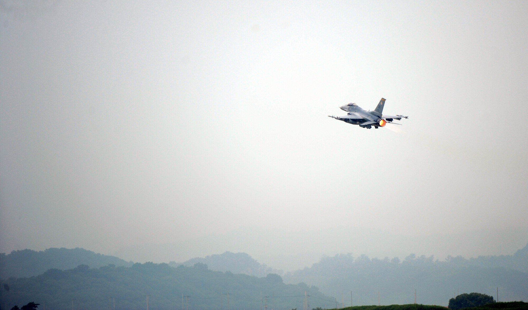 An F-16 Fighting Falcon from Shaw Air Force Base, S.C., takes off as one of the first combat sorties of Operational Readiness Exercise Beverly Midnight 13-03 at Osan Air Base, Republic of Korea, Aug. 6, 2013. The 55th Expeditionary Fighter Squadron arrived at Osan as part of the theater support package, and will be supporting operations during the week-long ORE. (U.S. Air Force photo/Staff Sgt. Sara Csurilla)
