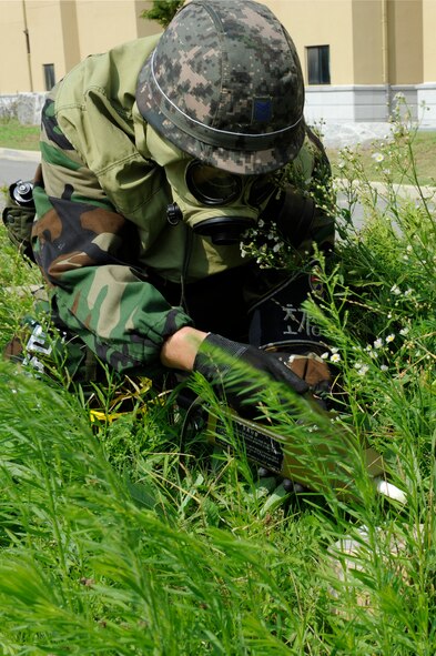 KUNSAN AIR BASE, Republic of Korea – Republic of Korea air force Master Sgt. Gong Myuang Park, 38th Fighter Group explosive ordinance disposal reconnaissance technician, sweeps a suspicious package outside the ROKAF medical campus during exercise Beverly Midnight 13-3, Aug. 5, 2013. Conducting a combined exercise allows U.S. Air Force and ROKAF airmen to observe and share different operating procedures. (U.S. Air Force photo by Staff Sgt. Tong Duong/Released)