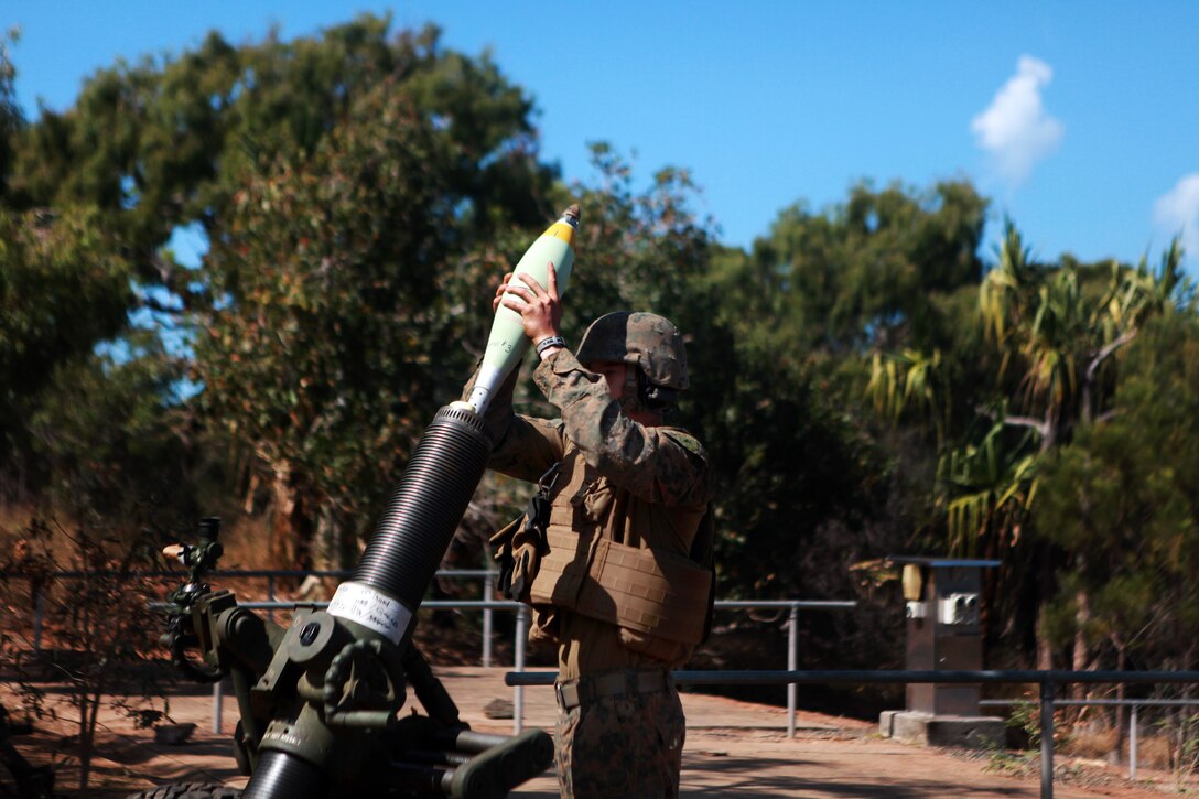 A U S Marine loads a round into an M327 120mm mortar during a four day A U S Marine loads a round into an M327 120mm mortar during a four day