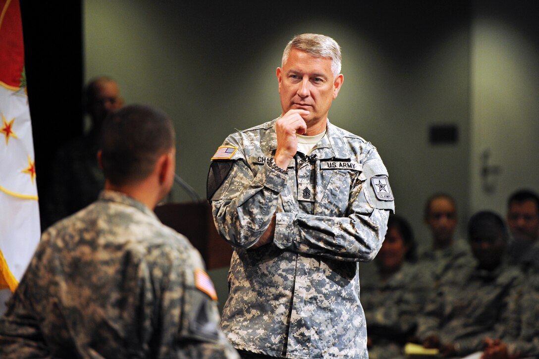 Sgt. Maj. of the Army Raymond F. Chandler III listens to a soldier's question during a town hall meeting at the Pentagon, Aug. 5, 2013.
