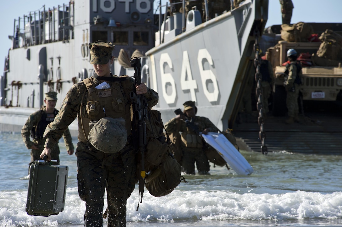 U.S. Marine Corps Cpl. Jacquelin Leombruno, assigned to Combat Logistics Battalion, 31st Marine Expeditionary Unit (MEU), embarked on the amphibious dock landing ship USS Germantown (LSD 42), gets out of Navy Landing Craft Utility 1646 during Talisman Saber 2013 in Shoalwater Bay, Australia, July 20, 2013. Talisman Saber is a combined biennial exercise between the U.S. and Australian militaries designed to enhance both nations? ability to respond to regional contingencies. (U.S. Navy photo by Mass Communication Specialist 3rd Class Christopher Lindahl/Released)