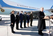 President George W. Bush, joined by Mrs. Laura Bush, stands outside Air Force One as he addresses his remarks in honor of Veterans Day, Tuesday, Nov. 11, 2008 upon the President's arrival at John F. Kennedy International Airport in New York. President Bush introduced military personnel representing the five branches of the armed services, who traveled with him aboard AF-1, honoring their service, from left are, U.S. Navy Chief Petty Officer Shenequa Cox of Dallas, Texas; U.S. Coast Guard Petty Officer First Class Christopher O. Hutto of Homer, Alaska; U.S. Army National Guard SSgt Michael Noyce-Merino of Melrose, Montana; U.S. Air Force Senior Airman Alicia Goetschel of Warrensburg, Mo., and U.S. Marine Corps Sgt. John Badon of Lufkin, Texas. Badon's bravery has earned him two Purple Hearts for his service in Operation Iraqi Freedom.