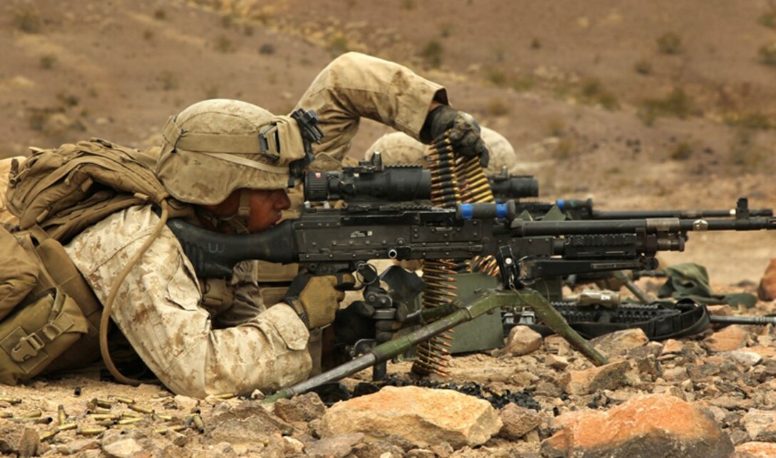 Marines with 1st Battalion, 9th Marines, 8th Marine Regiment, reload their 240B machine gun at a support by fire-position during a company-sized attack on Range 401 July 26. The battalion is currently conducting the Integrated Training Exercise in preperation of their upcoming deployment to Afghanistan later this year. 

