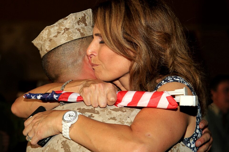 Robin Targon, mother of Lance Cpl. Eric Targon, Company D, 1st Tank Battalion, hugs her son’s friend, Cpl. Brandon Baber, at the units homecoming ceremony July 28, 2013.