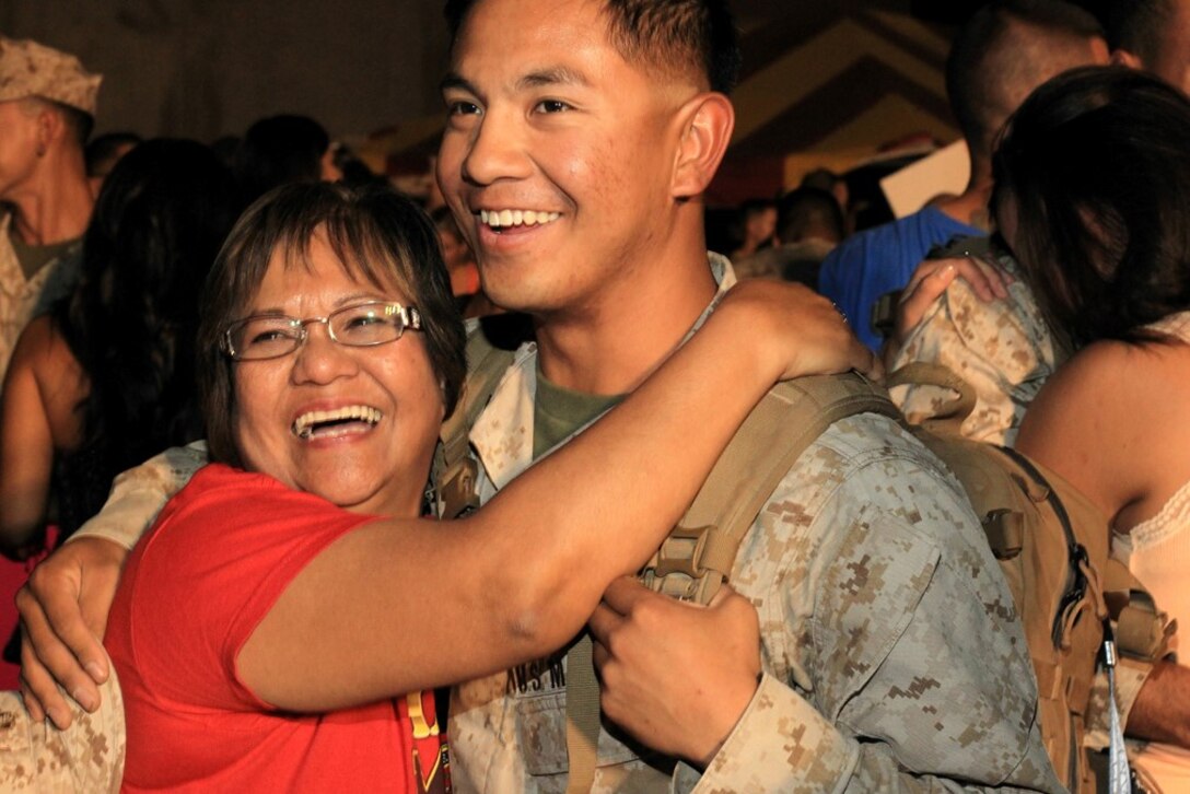 Cpl. Philip Lim, Company D, 1st Tank Battalion, reunites with his mother, Lenet, at the unit’s homecoming July 28, 2013.