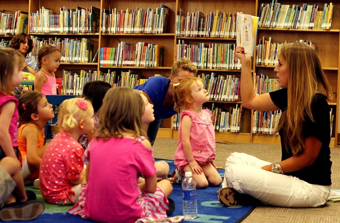 Ursula Morales, program coordinator, Combat Center Lifelong Learning Library, reads to children during storytime at the library July 30, 2013. 