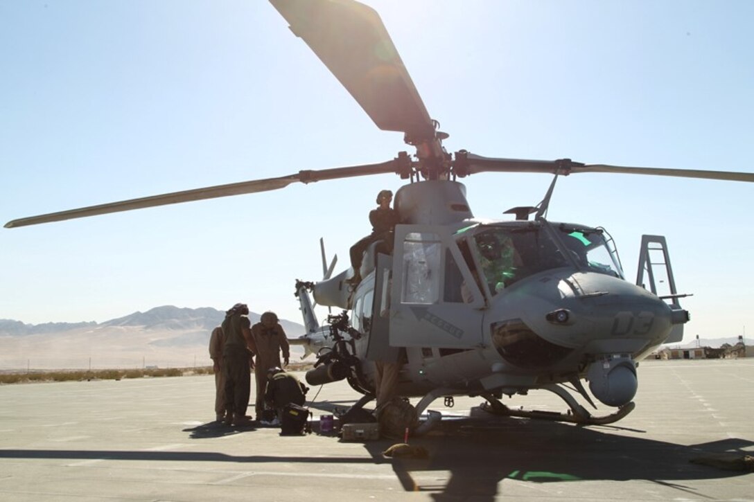 Marines with Marine Light Attack Helicopter Squadron 367 prepare their UH-1Y Super Huey for  a Tactical Recovery of Aircraft and Personnel mission at the Combat Center's Lavic Lake Training Area July 30. HMLA-367 utilized a UH-1Y to escort two CH-53's, which carried Marines and sailors with Weapons Company, 3rd Battalion, 7th Marine Regiment, to rescue the simulated downed pilot. ‘Scarface’ is here in support of the on-going Integrated Training Exercise.