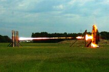 A round from a Shoulder-launched Multipurpose Assault Weapon, or SMAW, hits a target at Naval Surface Warfare Center Dahlgren Division. The SMAW with the new modular ballistic sight was test fired there in July. 