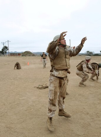 MARINE CORPS BASE CAMP PENDLETON, Calif. – Sergeant Carlos Camachorojas, parachute rigger and delivery specialist, 1st Reconnaissance Battalion, performs burpees with his teammates during a combat conditioning exercise, “Animal Kingdom,” as part of the Martial Arts Instructor Course at Edson Range here, July 30, 2013. Camachorojas, a native of Mesa, Ariz., said the exercise was the most challenging physical training he received during the three-week course. Teammates completed exercises while an individual Marine crawled and jumped through a square circuit. All Marines had to rotate through the circuit multiple times before the session ended, meaning teammates relied on each other to complete the course quickly.
(U.S. Marine Corps photo by Sgt. Jacob H. Harrer)