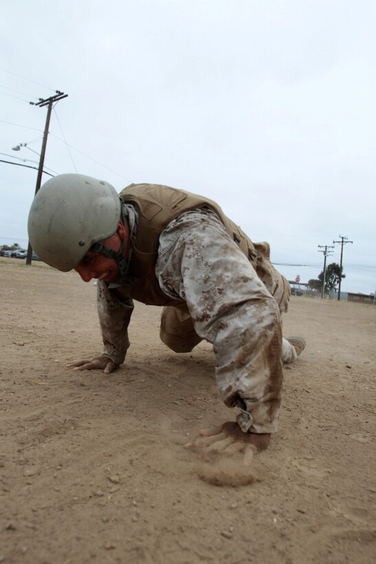 MARINE CORPS BASE CAMP PENDLETON, Calif. – Sergeant Carlos Camachorojas, parachute rigger and delivery specialist, 1st Reconnaissance Battalion, performs burpees with his teammates during a combat conditioning exercise, “Animal Kingdom,” as part of the Martial Arts Instructor Course at Edson Range here, July 30, 2013. Camachorojas, a native of Mesa, Ariz., said the exercise was the most challenging physical training he received during the three-week course. Teammates completed exercises while an individual Marine crawled and jumped through a square circuit. All Marines had to rotate through the circuit multiple times before the session ended, meaning teammates relied on each other to complete the course quickly.
(U.S. Marine Corps photo by Sgt. Jacob H. Harrer)