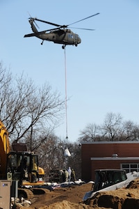 "Sand bombs" were delivered by a UH-60 helicopter to the Oak Grove Lutheran School in an effort to stop the water from flowing into the school on Sunday, March 29, 2009.