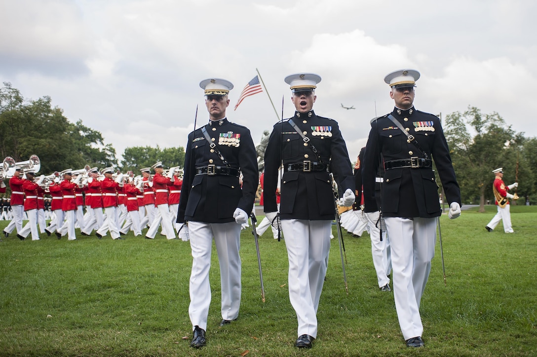 The parade staff performs during a Tuesday Sunset Parade at the Marine Corps War Memorial in Arlington, Va., Aug. 6. Kenichiro Sasae, ambassador of Japan to the United States, was the parade’s guest of honor. The U.S. considers Japan one of its closest allies and partners, and both share a firm and active political relationship.
