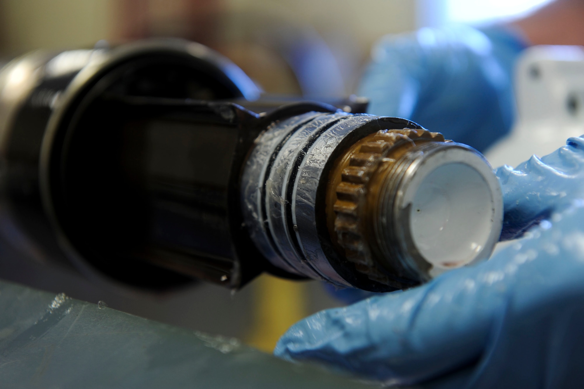 U.S. Air Force Airman 1st Class Scott Garrett, 18th Component Maintenance Squadron hydraulics apprentice, inspects and puts petroleum jelly on the seals of an F-15 Eagle aircraft nose landing gear strut on Kadena Air Base, Japan, Aug. 6, 2013. The 18th CMS is responsible for test measurement and diagnostic equipment services to the wing and associate units, as well as maintenance services essential to daily aircraft sortie production and unit deployments. (U.S. Air Force photo by Airman 1st Class Justin Veazie/Released)
