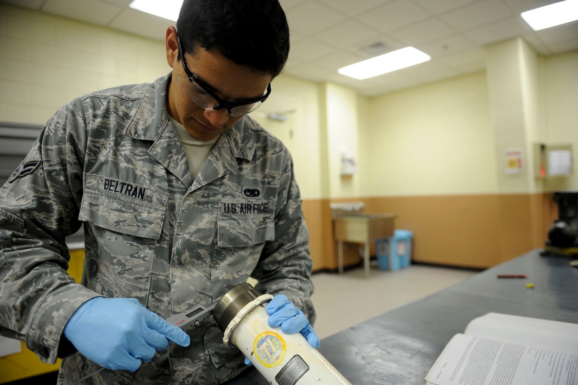 U.S. Air Force Airman 1st Class Christopher Beltran, 18th Component Maintenance Squadron hydraulics apprentice, checks the measurements of an F-15 Eagle aircraft cylinder barrel on Kadena Air Base, Japan, Aug. 6, 2013. The 18th CMS provides maintenance on electronics for propulsion, avionics and airframe accessory sub-systems for all assigned aircraft on Kadena and maintains the only four-bay engine test facility in Pacific Air Forces. (U.S. Air Force photo by Airman 1st Class Justin Veazie/Released)