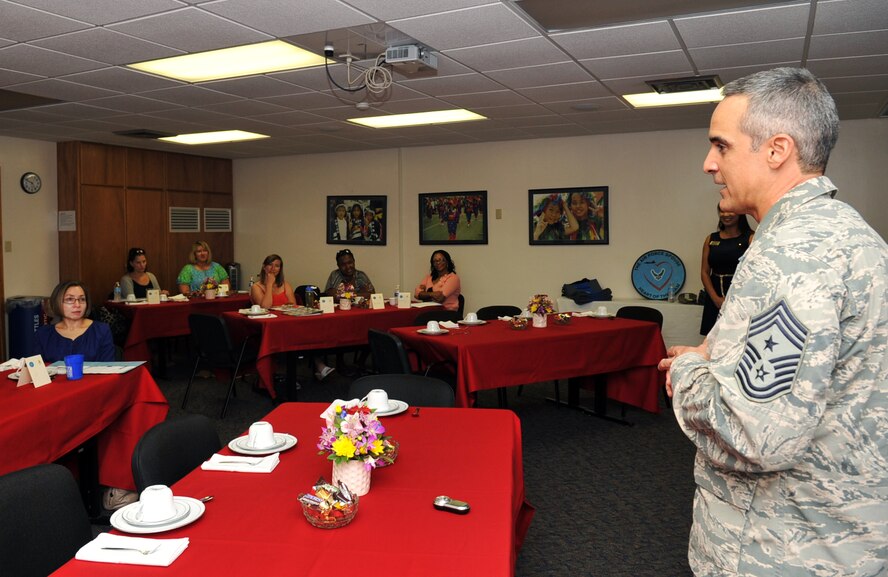 U.S. Air Force Chief Master Sgt. Ramon Colon-Lopez, 18th Wing command chief, gives a brief to new spouses during the Heart Link program at the Kadena Airman & Family Readiness Center on Kadena Air Base, Japan, Aug. 7, 2013. The Heart Link program helps new spouses strengthen military families, enhance mission readiness and learn more about military customs, services and resources. (U.S. Air Force photo by Naoto Anazawa/Released)
