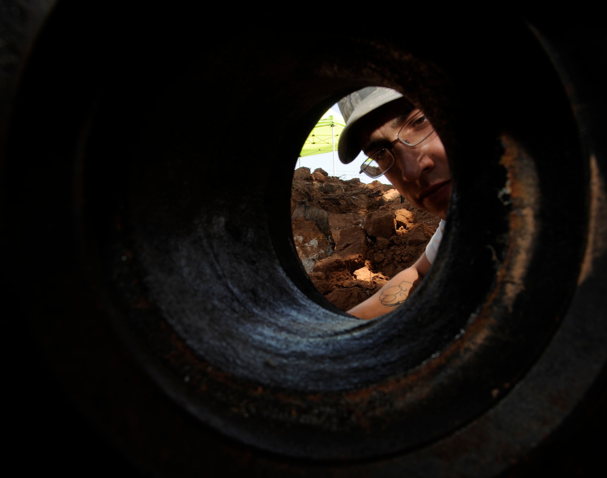 Senior Airman Michael Bustamante, 2nd Civil Engineer Squadron Water and Fuels Systems Maintenance craftsman, inspects a 45 degree mechanical joint during the installation of a fire hydrant on Barksdale Air Force Base, La., Aug. 7, 2013.  The fire hydrant is one of five to be replaced on base due to being inoperable. (U.S. Air Force photo/Airman 1st Class Andrew Moua)