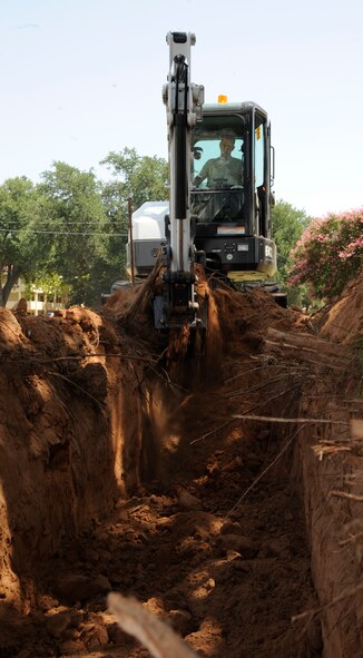 Mike Scott, 2nd Civil Engineer Squadron Water and Fuels Systems Maintenance journeyman, digs a trench with an excavator on Barksdale Air Force Base, La., Aug. 7, 2013. Scott dug three feet into the ground in order to place piping for a fire hydrant. (U.S. Air Force photo/Airman 1st Class Andrew Moua)