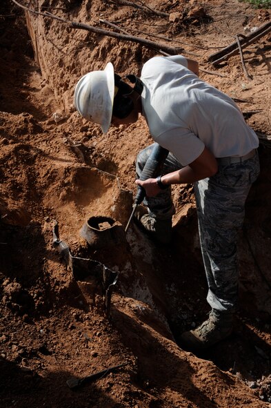 Senior Airman Michael Bustamante, 2nd Civil Engineer Squadron Water and Fuels Systems Maintenance craftsman, uses a jackhammer to remove concrete during the installation of a fire hydrant on Barksdale Air Force Base, La., Aug. 7, 2013. Once installed, the fire hydrant will be able to provide firefighting crew with 400 gallons of water per minute. (U.S. Air Force photo/Airman 1st Class Andrew Moua)