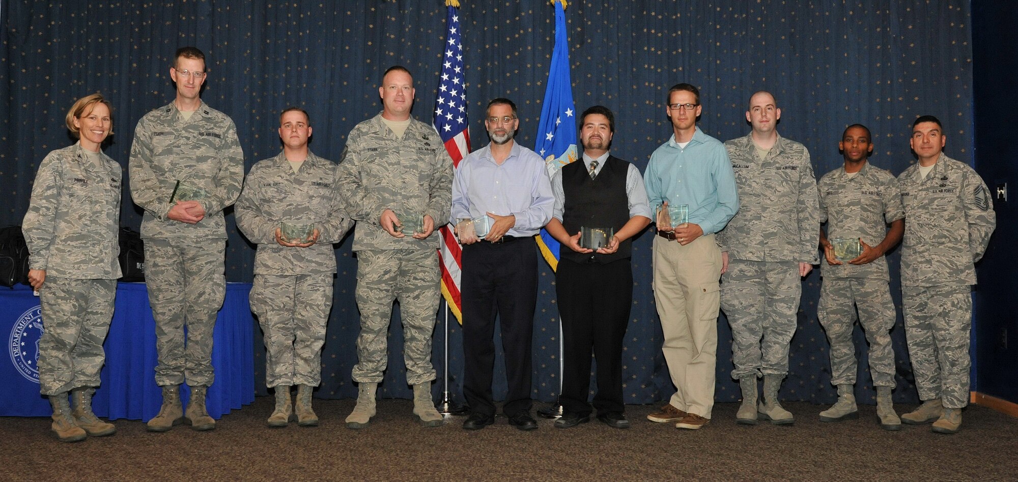 Nine Airmen were recognized during the Team Kirtland Second Quarter Awards ceremony Aug. 7 at the Mountain View Club. The award recipients and their respective award category were, from left, Capt. Steven Pugh, Company Grade Officer of the quarter; Staff Sgt. Schope Van Ert, Honor Guard member of the quarter; Master Sgt. Rory Stark, Senior NCO of the quarter; Terry Mest, Civilian Category I; Vance Oas, Civilian Category II; Whitney Reynolds, Civilian Category III; Staff Sgt. Glen McCallum, NCO of the quarter; and Airman 1st Class Franklin Jones, Airman of the Quarter. Donald Wittich, Civilian Category IV, is not pictured. (Photo by Ken Moore)