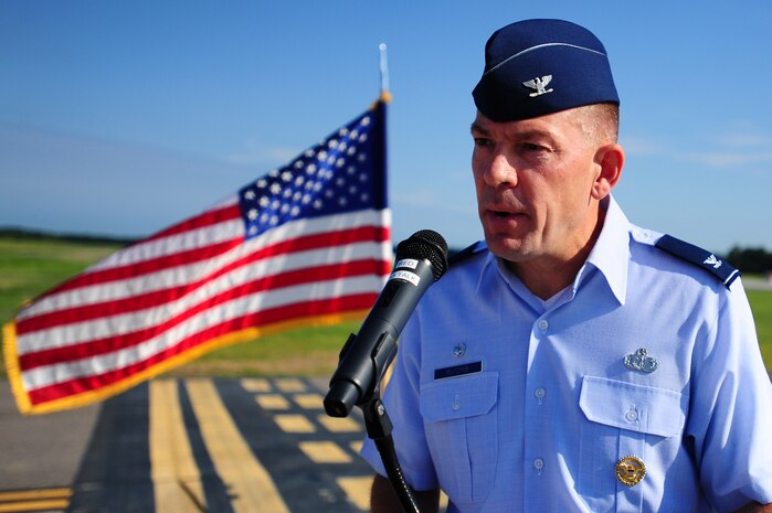 Col. Richard McComb, Joint Base Charleston commander, speaks during the opening of new the JB Charleston Runway Aug. 7, 2013, at JB Charleston – Air Base, S.C. The construction project began last summer to replace the aging main runway, which was more than 50 years old.  The original runway was safely kept in service by routine inspections and conducting spot repairs. (U.S. Air Force photo/Airman 1st Class Chacarra Neal)