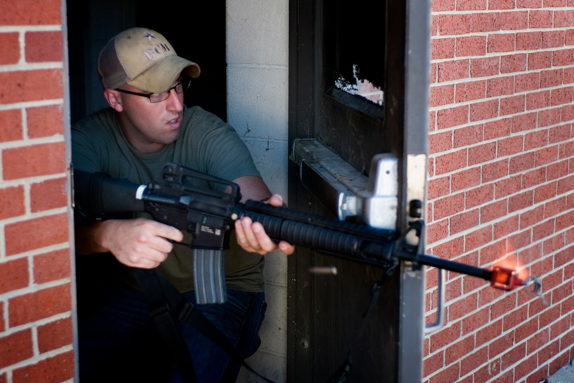 U.S. Marine Cpl. Charlie Cummins, Detachment One, Communication Company, Combat Logistics Regiment 45, 4th Marine Logistics Group supply specialist, fires an M-16 rifle loaded with blank ammunition at fellow Marines attacking his position during a joint, mass-casualty exercise held at Grissom Air Reserve Base, Ind., Aug. 4, 2013. Cummins and other Marines played the opposing force during the scenario that brought Grissom's Airmen, Soldiers and Marines together in a joint operation that was held at a simulated overseas location. (U.S. Air Force photo/Tech. Sgt. Mark R. W. Orders-Woempner) 