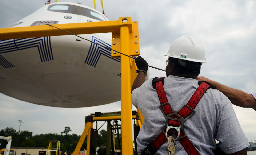 Contractors place the Orion Space Capsule aboard a Navy vessel for transport, Aug. 7, 2013, at Fort Eustis, Va. The capsule had a stopover at Fort Eustis before being moved to Norfolk for testing. (U.S. Air Force photo by Airman 1st Class Austin Harvill/Released)