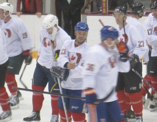Lt. Col. Rick Erredge (#27) skates with NHL stars Aug. 3 during a game that helped raise funds to help children in military families participate in hockey programs. (Air Force Photo by Master Sgt. Al McCann)