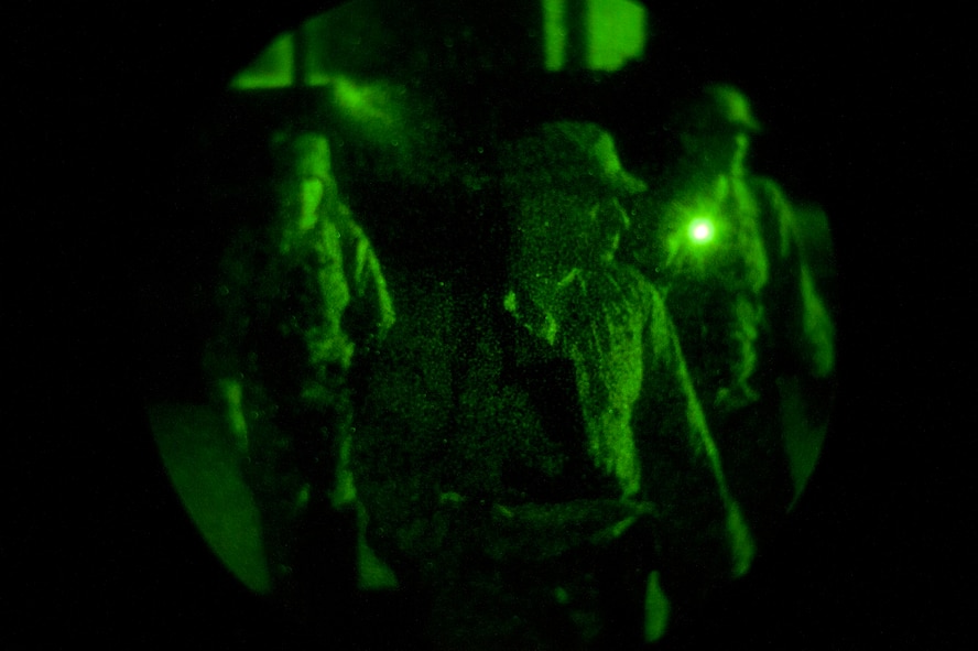 KUNSAN AIR BASE, Republic of Korea -- Senior Airman Dennis Petzold, 8th Civil Engineer Squadron exercise post-attack reconnaissance team lead, guides his team in an area sweep during an operational readiness exercise Aug. 8, 2013. After a building was “attacked” by mortars and they were given an “all clear,” a PAR sweep was initiated to ensure the area was safe and secure to continue operations. (U.S. Air Force photo by Senior Airman Armando A. Schwier-Morales/ Released)