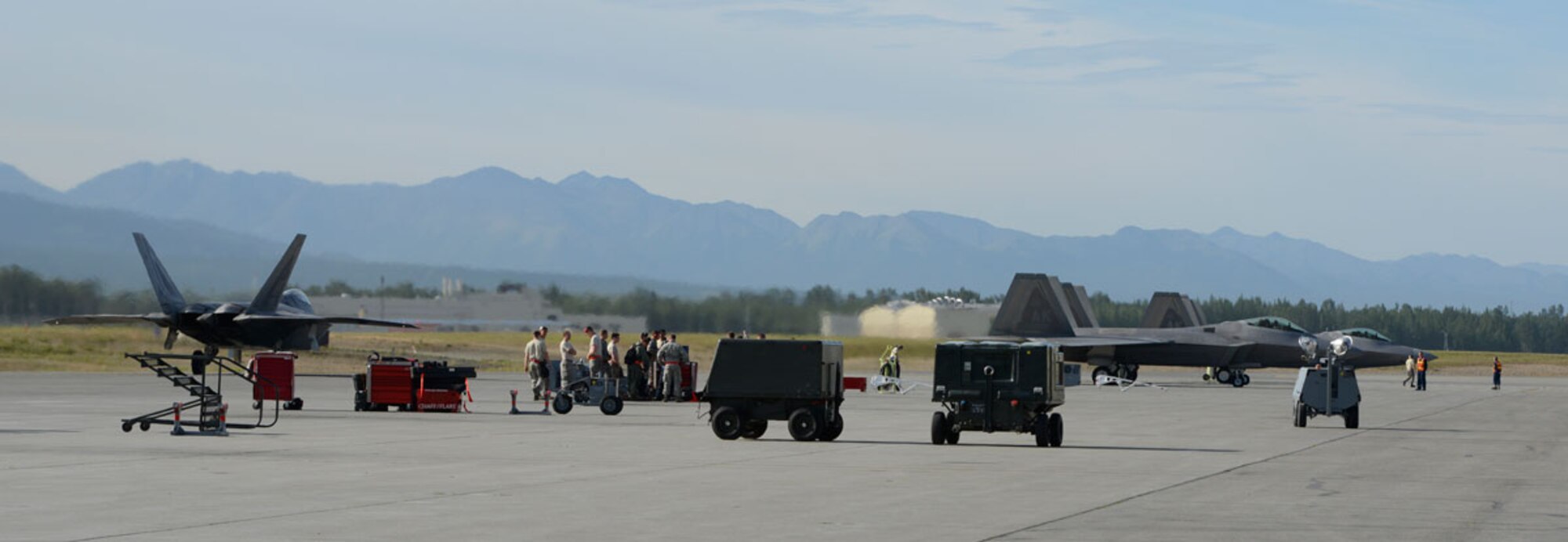 Airmen prepare F-22 Raptors to taxi on the flightline during Exercise Polar Force 13-5 on Joint Base Elmendorf-Richardson, Alaska, July 23. The exercise validated the base's ability to integrate, mobilize, and prepare assigned personnel, aircraft and equipment for a wartime mission and to employ forces and weapons systems to perform tasked missions. (U.S. Air Force photo/Airman 1st Class Tammie J. Ramsouer)