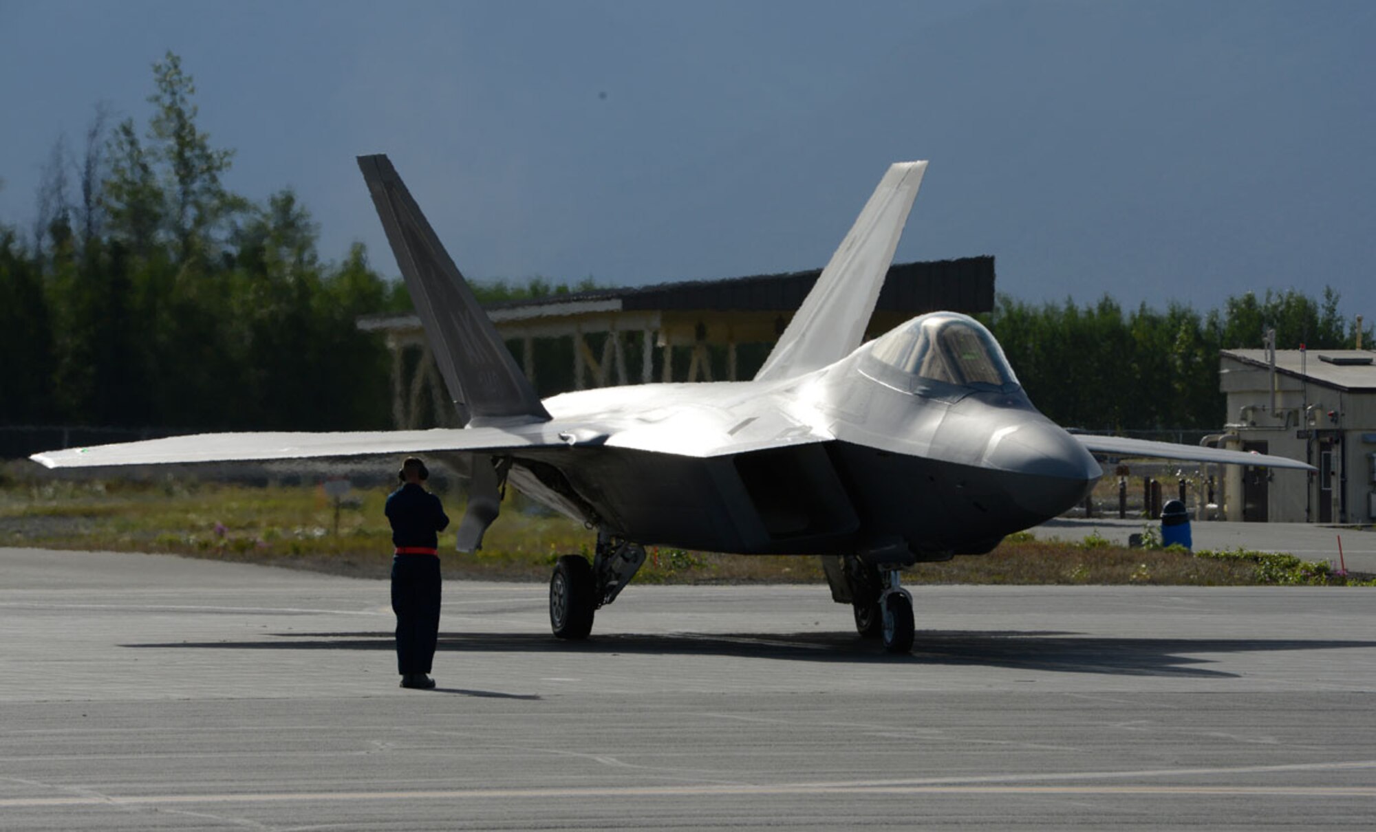 An Airman marshals in an F-22 Raptor during Exercise Polar Force 13-5 on Joint Base Elmendorf-Richardson, Alaska, July 23. The exercise validated the base's ability to integrate, mobilize, and prepare assigned personnel, aircraft and equipment for a wartime mission and to employ forces and weapons systems to perform tasked missions. (U.S. Air Force photo/Airman 1st Class Tammie J. Ramsouer)