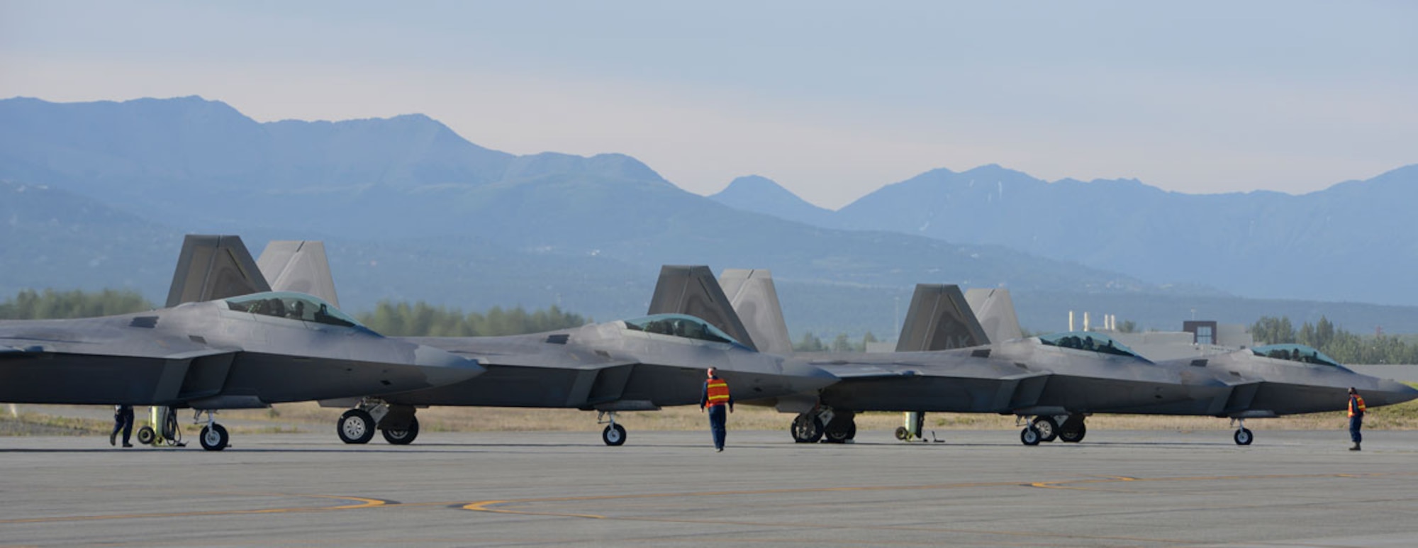 Airmen prepare F-22 Raptors to taxi on the flightline during Exercise Polar Force 13-5 on Joint Base Elmendorf-Richardson, Alaska, July 23. The exercise validated the base's ability to integrate, mobilize, and prepare assigned personnel, aircraft and equipment for a wartime mission and to employ forces and weapons systems to perform tasked missions. (U.S. Air Force photo/Airman 1st Class Tammie J. Ramsouer)