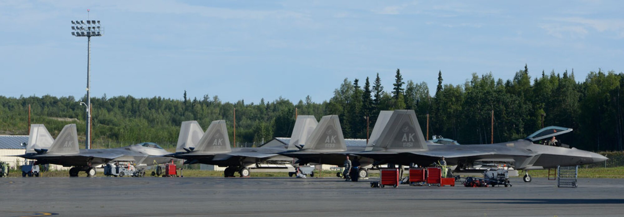 F-22 Raptors are parked on the flightline during Exercise Polar Force 13-5 on Joint Base Elmendorf-Richardson, Alaska, July 23. The exercise validated the base's ability to integrate, mobilize, and prepare assigned personnel, aircraft and equipment for a wartime mission and to employ forces and weapons systems to perform tasked missions. (U.S. Air Force photo/Airman 1st Class Tammie J. Ramsouer)
