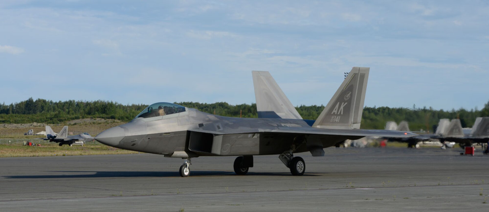 F-22 Raptors taxi on the runway during Exercise Polar Force 13-5 on Joint Base Elmendorf-Richardson, Alaska, July 23. The exercise validated the base's ability to integrate, mobilize, and prepare assigned personnel, aircraft and equipment for a wartime mission and to employ forces and weapons systems to perform tasked missions. (U.S. Air Force photo/Airman 1st Class Tammie J. Ramsouer)