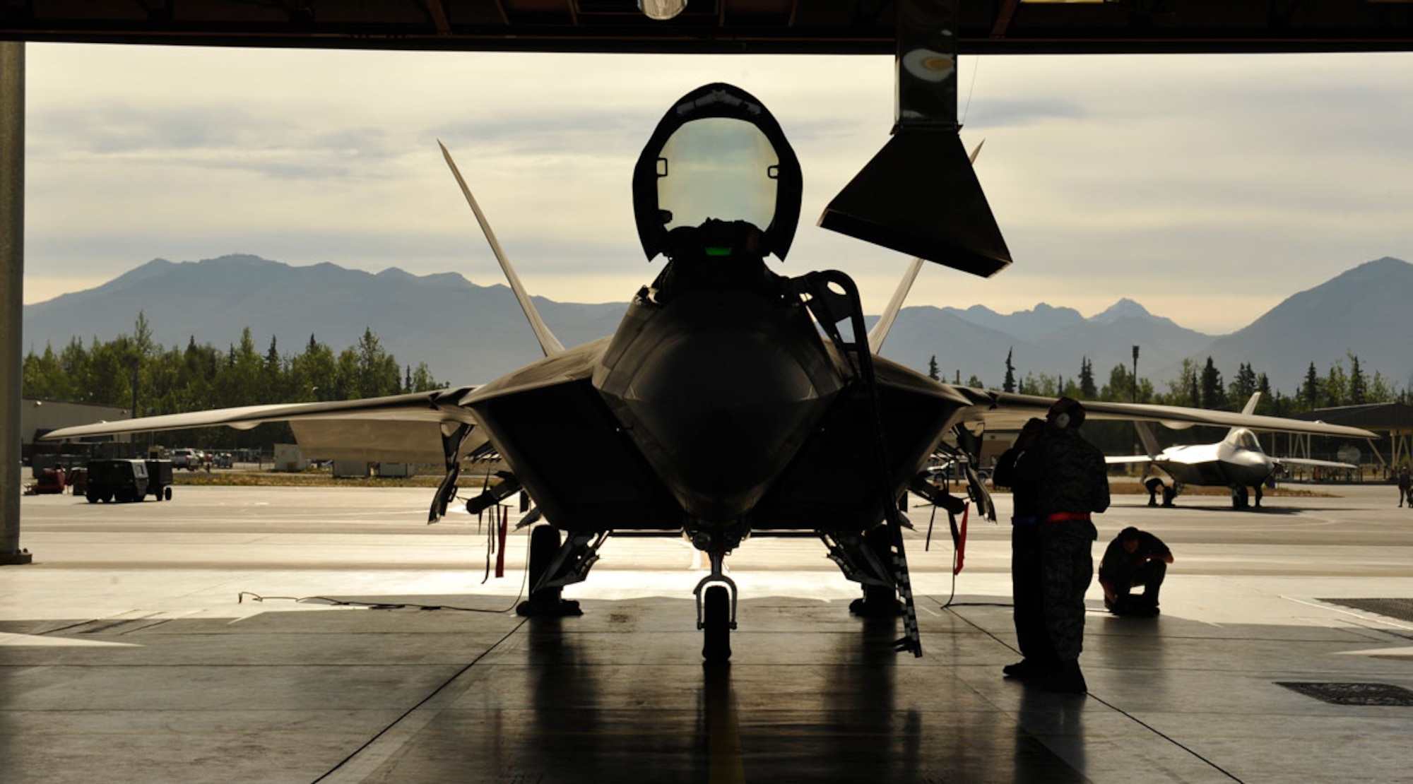 Airmen from the 90th Fighter Squadron repair an F-22 Raptor during Exercise Polar Force 13-5 on Joint Base Elmendorf-Richardson, Alaska, July 23. The exercise is validated the base's ability to integrate, mobilize, and prepare assigned personnel, aircraft and equipment for a wartime mission and to employ forces and weapons systems to perform tasked missions. (U.S. Air Force photo/Airman 1st Class Tammie J. Ramsouer)