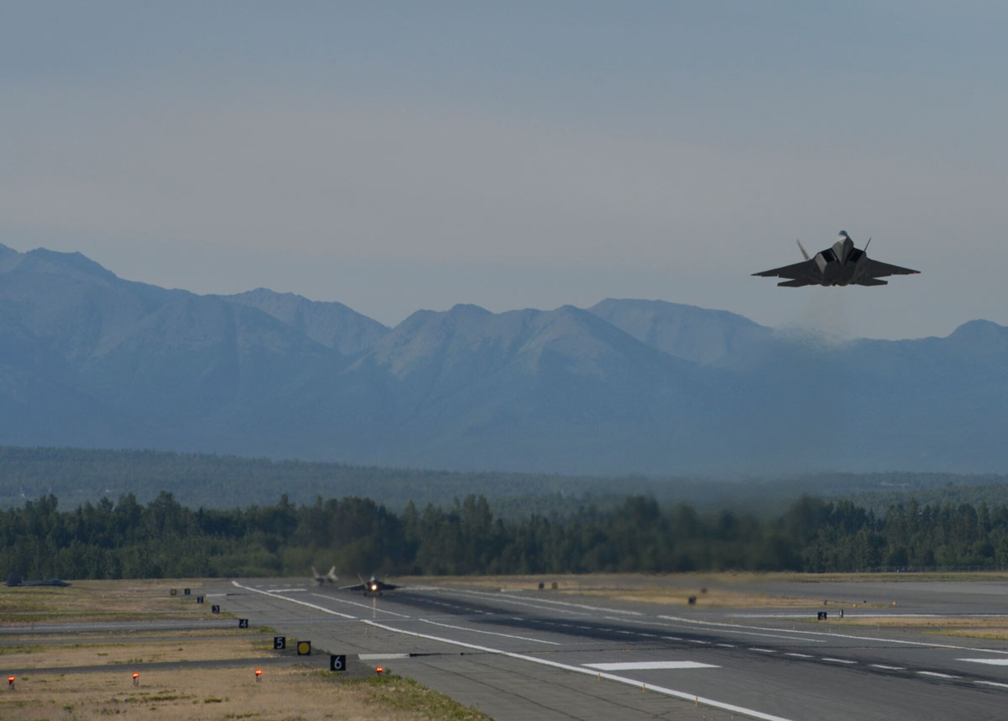 An F-22 Raptor takes off during Exercise Polar Force 13-5 on Joint Base Elmendorf-Richardson, Alaska, July 23. The exercise validated the base's ability to integrate, mobilize, and prepare assigned personnel, aircraft and equipment for a wartime mission and to employ forces and weapons systems to perform tasked missions. (U.S. Air Force photo/Airman 1st Class Tammie J. Ramsouer)