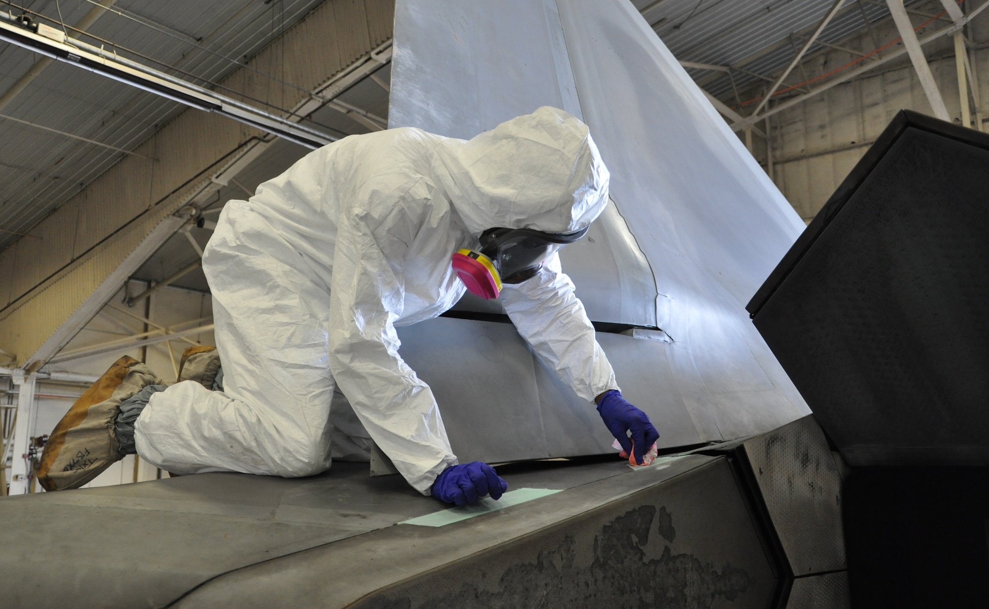 Airman 1st Class Freddie Newman, 325th MXS Low Observable apprentice, applys a layer of coating to an F-22 Raptor Aug. 1 at Tyndall Air Force Base. The 325th Maintenance Squadron Low Observable makes sure the F-22 s at Tyndall maintain their stealth capabilities by restoring and maintaining the Low Observable coatings on the aircraft. (U.S. Air Force photo by Airman 1st Class Alex Echols)