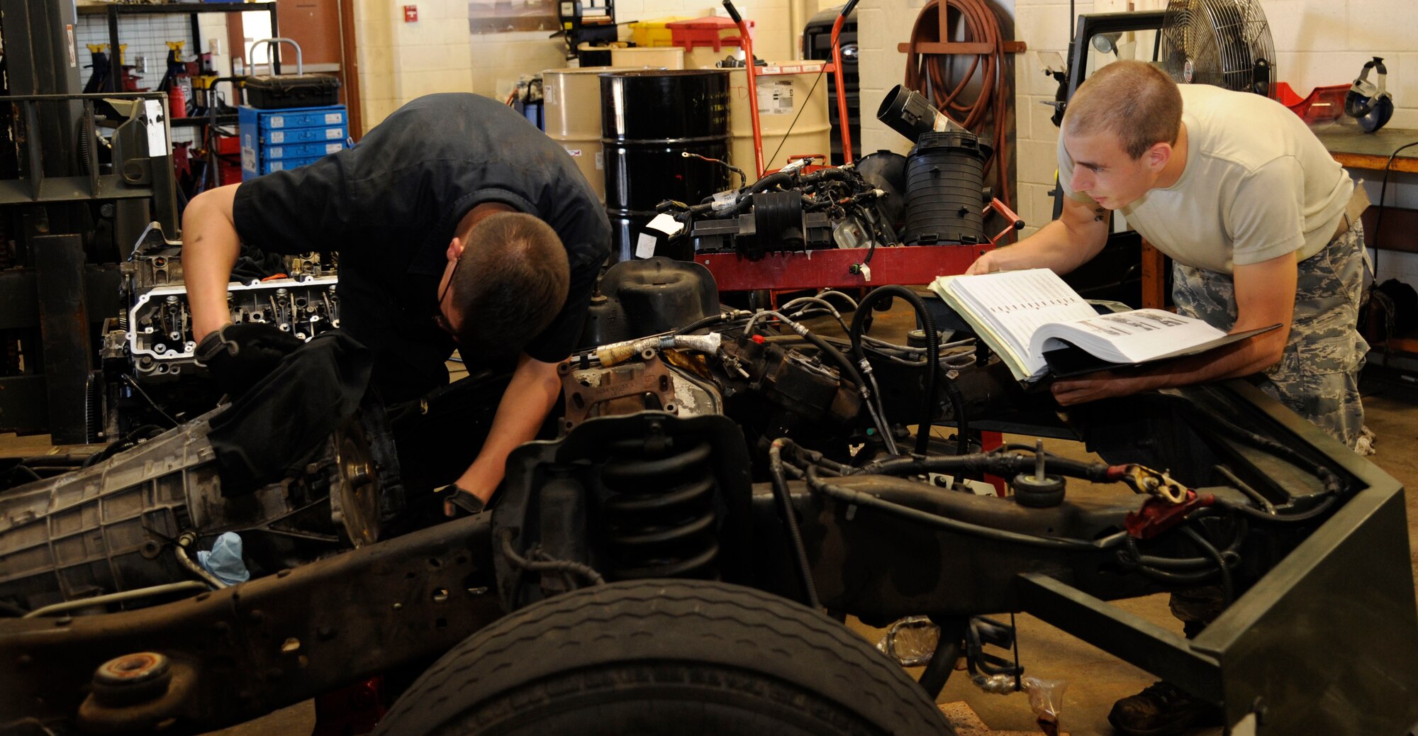 Airmen 1st Class Daniel Ward, left, and Aaaron Bello, from the 2nd Logistics Readiness Squadron vehicle maintenance journeymen, inspect a torque converter on Barksdale Air Force Base, La., Aug. 6, 2013. The inspection was performed during preventative maintenance to ensure proper function. (U.S. Air Force photo/Airman 1st Class Andrew Moua)