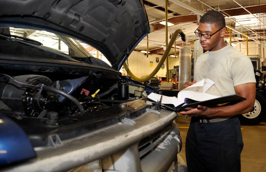 Airman 1st Class Jamil Dixon, 2nd Logistics Readiness Squadron vehicle maintenance journeyman, looks over a Technical Order on Barksdale Air Force Base, La., Aug. 6, 2013. TOs are step-by-step instruction manuals used by Airmen that list proper tools needed, hazards to be aware of and protective gear needed to accomplish the task safely. (U.S. Air Force photo/Airman 1st Class Andrew Moua)
