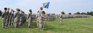 Airmen from Langley Air Force Base, Va., stand at parade rest while in formation before the “We Are Family” base retreat ceremony, July 31, 2013. The “We Are Family” campaign is a Langley initiative that aims to prevent sexual assault through awareness. (U.S. Air Force photo by Senior Airman Brittany Paerschke-O’Brien/Released)