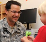 Capt. Javier A. Padial, 5th Medical Group health care provider, interacts with a patient, July 29, 2013. The 5th Medical Group is beginning patient registrations for MiCare, the Air Force Medical Service's military online confidential secure messaging service. (U.S. Air Force photo/Airman 1st Class Andrew Crawford)