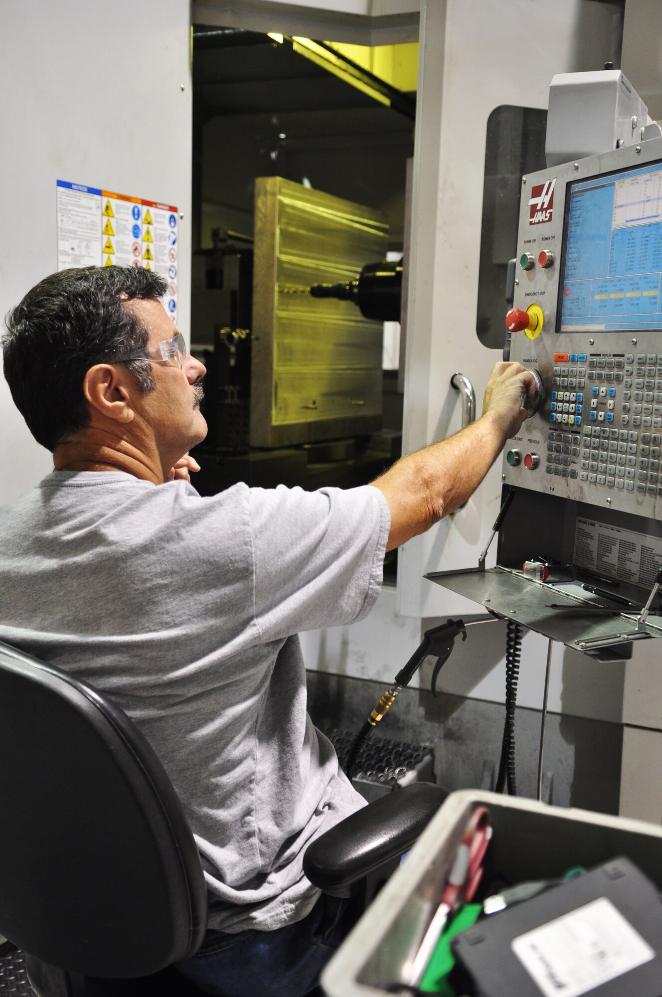 Curtis Ellison readies an aluminum 'sacrificial' plate in a horizontal mill where he is preparing to machine clamps that will be used in the engine test cells. Mr. Ellison is a tool maker with the 76th Propulsion Maintenance Group Repair and Development unit. When engine maintenance workers in the Oklahoma City Air Logistics Complex need parts or tools to get their jobs done, they turn to the engineers and tool makers of the R&D unit. (Air Force photo by Micah Garbarino)