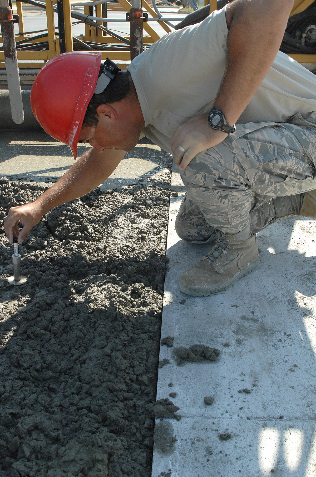 U.S. Air Force Staff Sgt. Christopher Lange, 823rd Rapid Engineer Deployable Heavy Operational Repair Squadron Engineers engineering technician, performs a concrete slump test during a training TDY at Seymour Johnson Air Force Base, N.C., July 26, 2013.  The slump test is used to ensure uniformity between individual batches of concrete.  (U.S. Air Force photo by Airman 1st Class Brittain Crolley)