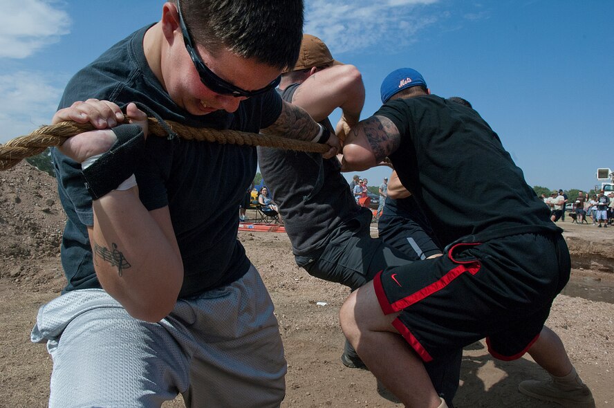 Senior Airman Rubye Coffey, 90th Missile Security Forces Squadron, competes on the 90th MSFS tug-of-war team in the annual F.E. Warren Air Force Base, Wyo., Frontiercade festivities Aug. 24, 2012. The 90th MSFS and the team from the 790th Missile Security Forces Squadron struggled back and forth for almost three-and-a-half minutes before the 90th MSFS fell. Representatives are signing up personnel from their respective organizations to participate in this year’s event. (U.S. Air Force photo by R.J. Oriez)