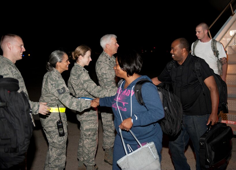 KUNSAN AIR BASE, Republic of Korea -- The 8th Fighter Wing chaplain team welcomes new Wolf Pack Airmen, Aug. 8, 2013. The arrival of new Airmen is just one of the real-world missions unaffected by exercise Beverly Midnight 13-3. (U.S. Air Force photo by Senior Airman Clayton Lenhardt / Released)