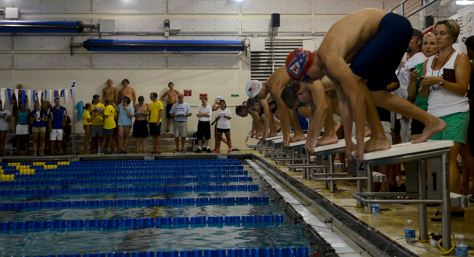 A group of swimmers ages 15 through 18 take their stances before a race, Aug. 3, 2013, at Fort Eustis, Va.  The Virginia Peninsula Swimming Union and Greater Peninsula Swimming Association championships are the aquatic center's largest events of the year. (U.S. Air Force photo by Airman 1st Class Austin Harvill/Released)