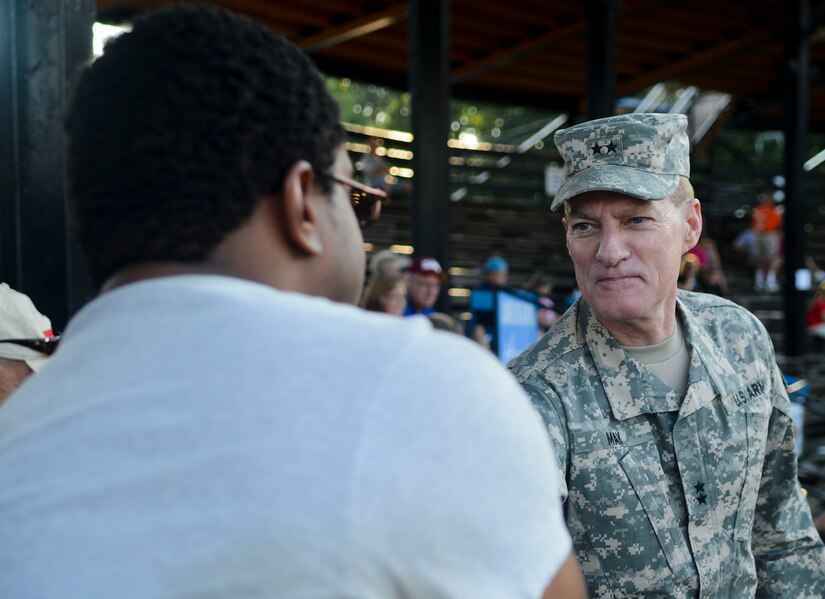 U.S. Army Maj. Gen. Bradley May, Training and Doctrine Command Initial Military Training Center of Excellence deputy commander, greets Gold Star family members, Aug. 3, 2013, in Hampton, Va. Gold Star families were offered free admission to a baseball game with the help of the Fort Eustis, Va., Survivor Outreach Services. (U.S. Air Force photo by Airman 1st Class Austin Harvill/Released)