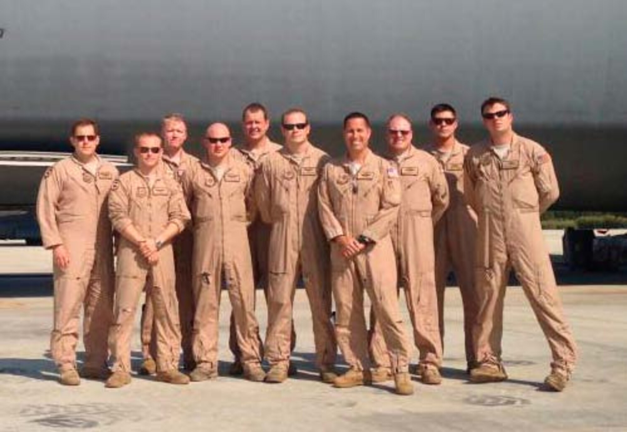 Crew members, slated to receive the 2013 Earl T. Ricks award pose in front of a C-5 Galaxy April 19, 2013. During an overseas mission the aircraft struck multiple birds during takeoff. Two engines were damaged but the crew manged to return the aircraft safely to the airfield.